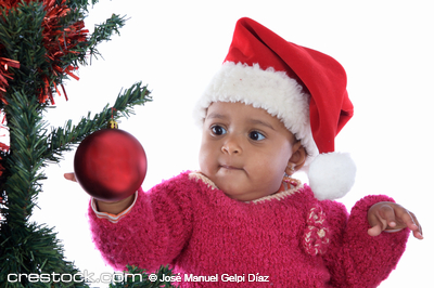 Adorable baby girl playing with christmas tree...