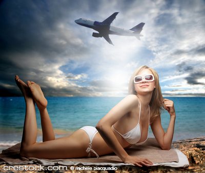 a beautiful woman on the beach and a airplane
